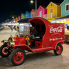 Coca-Cola retro mobile food truck parked in a tropical night market with palm trees
