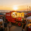 Illuminated Coca-Cola vintage food truck in a bustling tropical night market